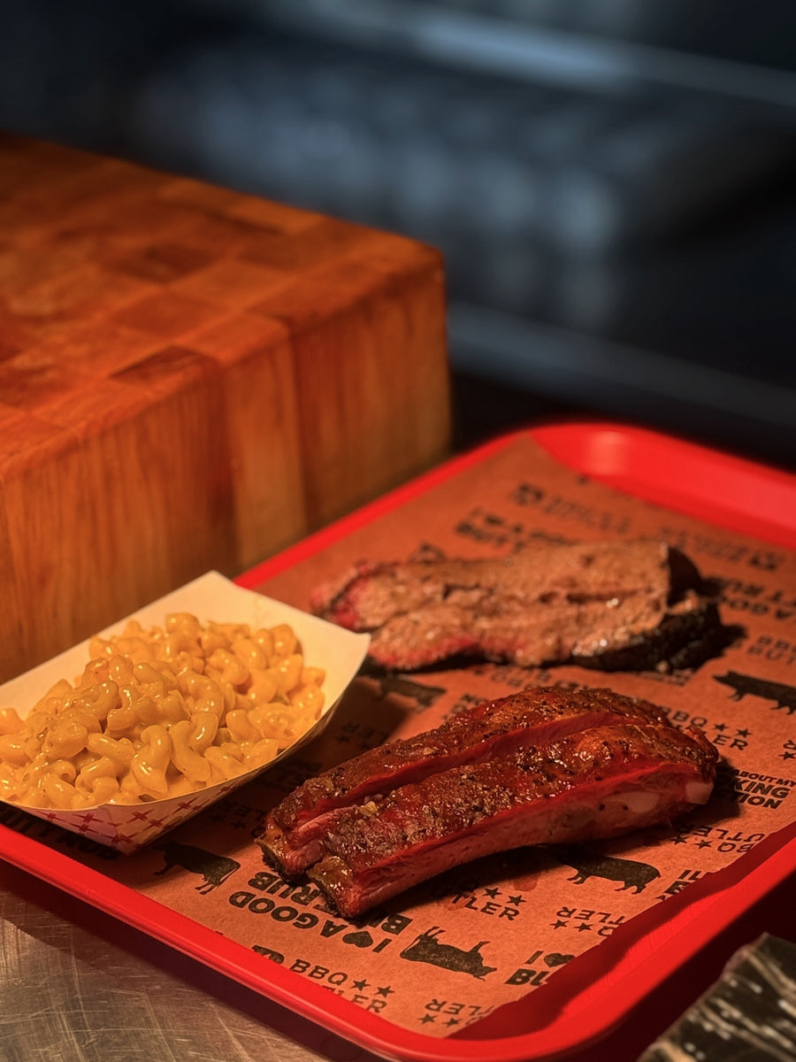 Brisket, ribs and macaroni and cheese on a tray at Kenny J’s BBQ
