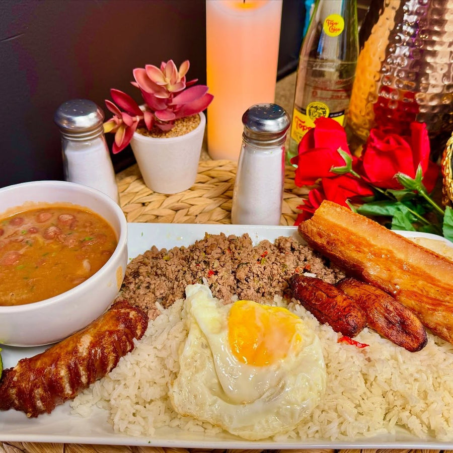 Colombian platter with rice, fried egg, meats and beans at Parcerito