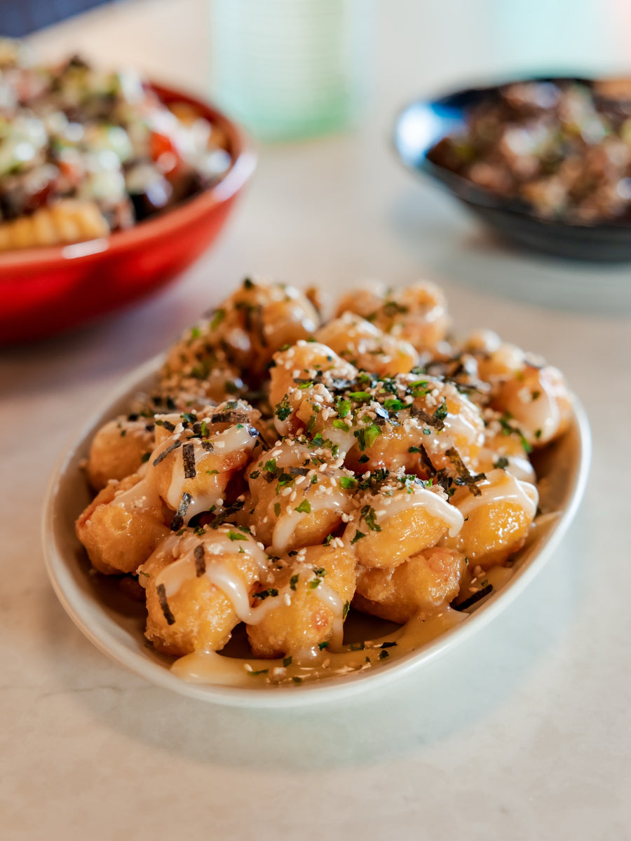 Furikake chicken topped with sauce and sesame seeds at Side of Aloha